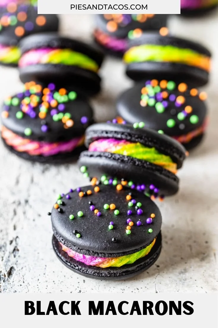 Beautifully arranged black macarons on a dessert table.