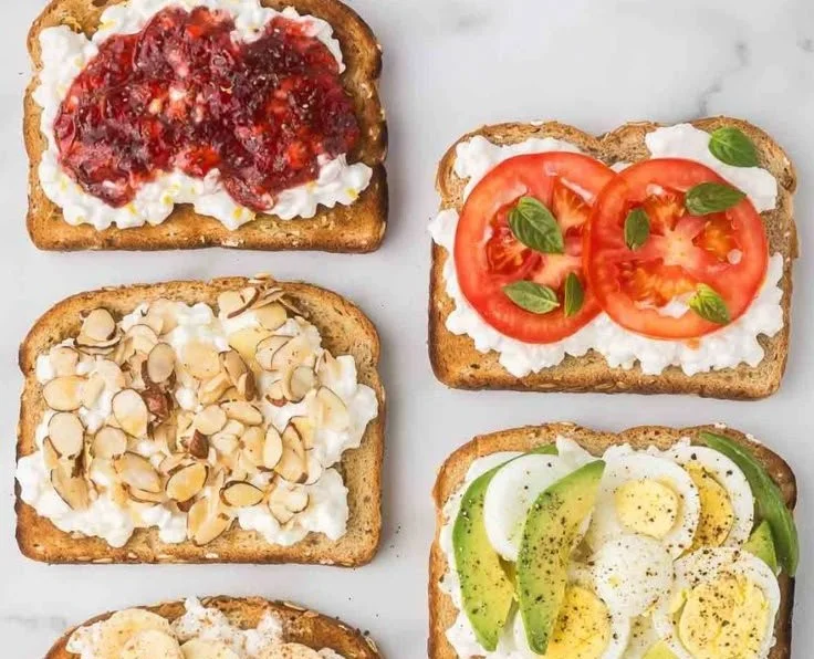 High protein cottage cheese toast topped with fruits and herbs for a healthy meal.