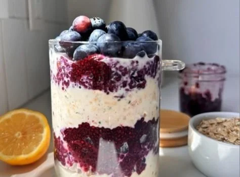 High-protein lemon blueberry overnight oats in a glass jar topped with blueberries.