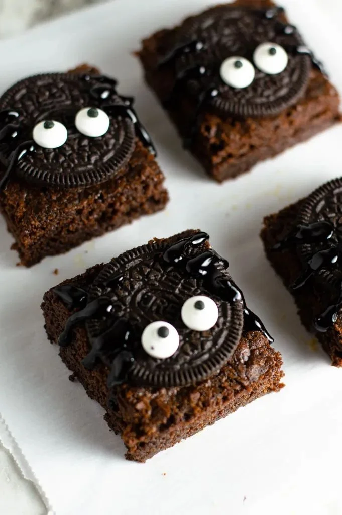 Nutella Spider Brownies topped with a chocolate spider web design