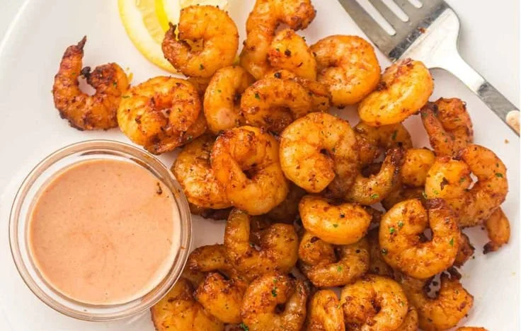 Deliciously cooked air fryer shrimp served on a plate.
