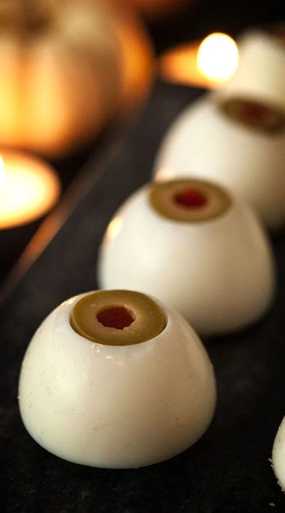 Spooky deviled eyeballs served on a platter for Halloween.