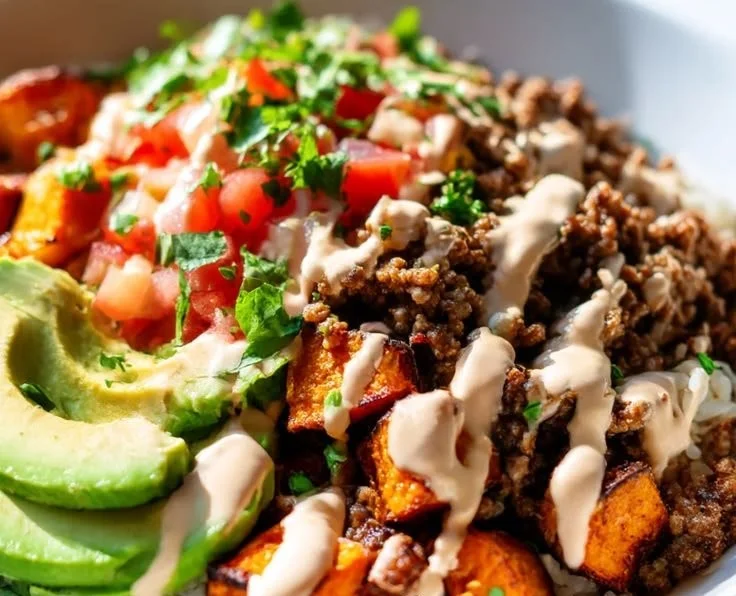 Sweet potato taco bowl with savory ground beef and fresh toppings